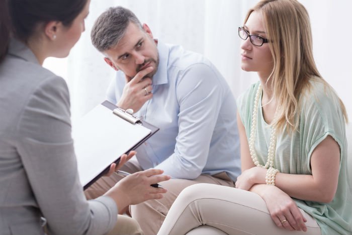 Couple talking to family law mediator