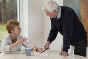 older couple arguing over paperwork