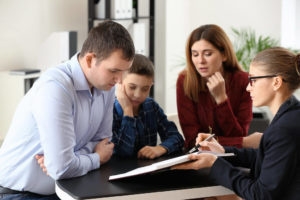 parents and child visiting a child custody attorney