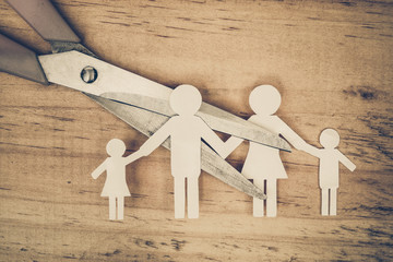 Scissors cutting paper cut of family