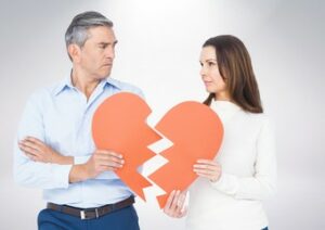 couple holding a broken heart - gray divorce concept