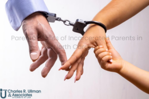 Handcuffed parent reaching for child’s hand — illustrating parental rights of incarcerated parents in North Carolina.